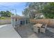 Outdoor patio area with dining table and chairs near shed at 8204 Constance Dr, Sarasota, FL 34243