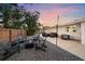 Backyard with fire pit, seating, string lights, and gravel at 8204 Constance Dr, Sarasota, FL 34243