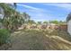 Spacious backyard with a wooden fence and grassy lawn at 8204 Constance Dr, Sarasota, FL 34243