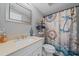 Nautically-themed bathroom with a white vanity, shower, and toilet at 8204 Constance Dr, Sarasota, FL 34243