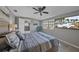 Bedroom with large TV, ceiling fan, and water view at 8204 Constance Dr, Sarasota, FL 34243
