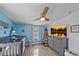 Bedroom with crib, dresser, and large TV at 8204 Constance Dr, Sarasota, FL 34243