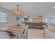 Bright dining area with wood table and chairs, view to living room at 8204 Constance Dr, Sarasota, FL 34243