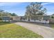 Ranch-style home with gray siding, white accents, and a carport at 8204 Constance Dr, Sarasota, FL 34243