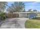 Ranch-style home with gray siding, white accents, and a carport at 8204 Constance Dr, Sarasota, FL 34243