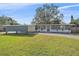 Ranch-style home with gray siding, white accents, and a carport at 8204 Constance Dr, Sarasota, FL 34243