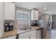 Kitchen features granite countertops, stainless steel appliances, and white cabinets at 8204 Constance Dr, Sarasota, FL 34243