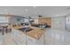 Modern kitchen with granite island, stainless steel appliances, and white cabinetry at 8204 Constance Dr, Sarasota, FL 34243