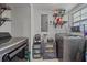Laundry room with washer, dryer, and ample storage shelves at 8204 Constance Dr, Sarasota, FL 34243