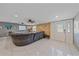 Bright living room with tile floors, sectional sofa, and entryway at 8204 Constance Dr, Sarasota, FL 34243