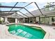 Resort-style pool and patio with covered lanai and lounge seating at 869 Forestview Dr, Sarasota, FL 34232