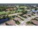 Expansive aerial view of community, highlighting golf course and lake at 8737 Pebble Creek Ln, Sarasota, FL 34238