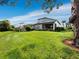 House with screened enclosure, overlooking a large backyard at 8737 Pebble Creek Ln, Sarasota, FL 34238