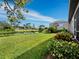 Home's backyard features a pond view and lush landscaping at 8737 Pebble Creek Ln, Sarasota, FL 34238