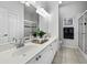 Bright bathroom boasts double vanity, large mirror, and shower at 8737 Pebble Creek Ln, Sarasota, FL 34238