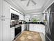 Modern kitchen featuring stainless steel appliances and white cabinetry at 8737 Pebble Creek Ln, Sarasota, FL 34238