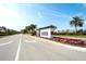 Beautiful community entrance sign with manicured landscaping, palm trees, and blue skies at 8739 52Nd E Ave, Bradenton, FL 34211