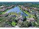Aerial view of a house showcasing its location on a lake within a community at 9420 Old Hyde Park Pl, Lakewood Ranch, FL 34202