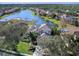 Aerial view showcasing a house with a lake view at 9420 Old Hyde Park Pl, Lakewood Ranch, FL 34202