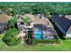 Backyard view of house featuring a pool and screened lanai at 9420 Old Hyde Park Pl, Lakewood Ranch, FL 34202