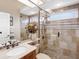 Elegant bathroom with a walk-in shower, tiled walls, and modern vanity at 9420 Old Hyde Park Pl, Lakewood Ranch, FL 34202