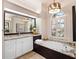Elegant bathroom with granite countertops and soaking tub at 9420 Old Hyde Park Pl, Lakewood Ranch, FL 34202