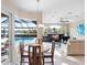 Bright dining area with pool views, and adjacent living room at 9420 Old Hyde Park Pl, Lakewood Ranch, FL 34202