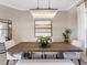 Elegant dining room featuring a wood table and chandelier at 9420 Old Hyde Park Pl, Lakewood Ranch, FL 34202