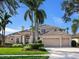 Two-story home with tile roof, landscaping, and three-car garage at 9420 Old Hyde Park Pl, Lakewood Ranch, FL 34202