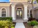 Elegant entryway with double doors and decorative columns at 9420 Old Hyde Park Pl, Lakewood Ranch, FL 34202