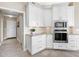 Bright kitchen features white cabinets, granite countertops, and stainless steel appliances at 9420 Old Hyde Park Pl, Lakewood Ranch, FL 34202