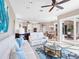 Open living room with large windows, comfortable seating, and kitchen views at 9420 Old Hyde Park Pl, Lakewood Ranch, FL 34202