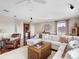 Large living area with hardwood floors, sectional sofa, and built-in wet bar at 9420 Old Hyde Park Pl, Lakewood Ranch, FL 34202