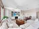 Living room with hardwood floors, built-in shelving, and a large TV at 9420 Old Hyde Park Pl, Lakewood Ranch, FL 34202
