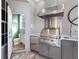 Outdoor kitchen with a built-in grill and a small powder room at 9420 Old Hyde Park Pl, Lakewood Ranch, FL 34202