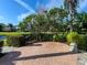 Brick patio with grill and lush landscaping at 9420 Old Hyde Park Pl, Lakewood Ranch, FL 34202