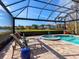 Relaxing pool and spa area with lounge chairs under a screened enclosure at 9420 Old Hyde Park Pl, Lakewood Ranch, FL 34202