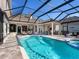 Spacious pool and spa with a covered patio and outdoor kitchen at 9420 Old Hyde Park Pl, Lakewood Ranch, FL 34202