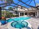 Inviting pool and spa with a covered patio and lush landscaping at 9420 Old Hyde Park Pl, Lakewood Ranch, FL 34202