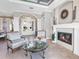 Spacious sitting area with fireplace, view of entry and pool at 9420 Old Hyde Park Pl, Lakewood Ranch, FL 34202