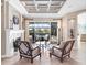 Bright sitting room with fireplace and access to pool area at 9420 Old Hyde Park Pl, Lakewood Ranch, FL 34202