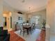 Formal dining room with hardwood floors and stylish light fixture at 9818 Discovery Ter, Bradenton, FL 34212