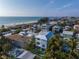 Aerial view of beach house community, showcasing a modern two-story home with a private pool at 105 6Th S St, Bradenton Beach, FL 34217