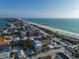 Aerial view of beach house community, showcasing a modern two-story home with a private pool at 105 6Th S St, Bradenton Beach, FL 34217