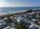 Aerial view of beach house community, showcasing a modern two-story home with a private pool near the beach at 105 6Th S St, Bradenton Beach, FL 34217