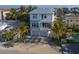 Aerial view of modern two-story home, featuring a metal roof and two-car garage at 105 6Th S St, Bradenton Beach, FL 34217