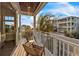 Relaxing balcony with two wicker chairs and a side table, offering views of the neighborhood at 105 6Th S St, Bradenton Beach, FL 34217