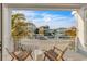 Two chairs and a small table on a balcony overlooking the neighborhood at 105 6Th S St, Bradenton Beach, FL 34217