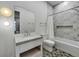 Charming bathroom with a white vanity, bathtub and leaf-patterned wall at 105 6Th S St, Bradenton Beach, FL 34217