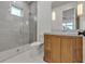 Modern bathroom with a glass shower, wooden vanity, and white toilet at 105 6Th S St, Bradenton Beach, FL 34217